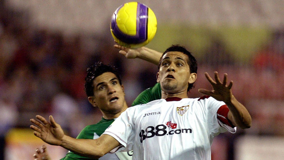Sevilla's Brazilian Dani Alves (R) holds