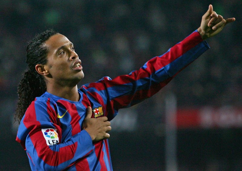 Barcelona's Ronaldinho of Brazil celebrates his goal against Sevilla during their Spanish first division soccer match at Nou Camp Stadium in Barcelona, Spain December 11, 2005. Barcelona won 2-1. REUTERS/ Albert Gea