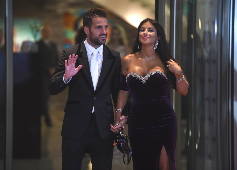 Chelsea's football player Cesc Fabregas and his wife pose on a red carpet upon arrival to attend Argentine football star Lionel Messi and Antonella Roccuzzo's wedding in Rosario, Santa Fe province, Argentina on June 30, 2017. Footballers and celebrities including pop singer Shakira gathered for the "wedding of the century" in Lionel Messi's Argentine hometown as the Barcelona superstar prepared to marry his childhood sweetheart Antonella Roccuzzo. / AFP PHOTO / EITAN ABRAMOVICH